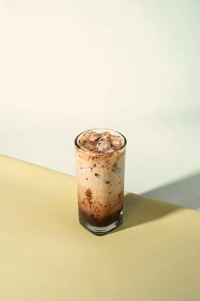 Iced latte with milk settling through the coffee